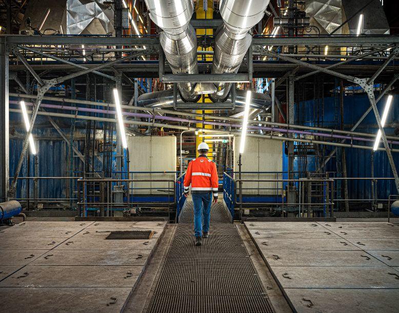 Veolia employee walks through industrial environment